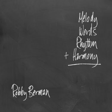 A blackboard with handwritten text listing "Melody, Words, Rhythm + Harmony" and "Robby Berman" at the bottom left.